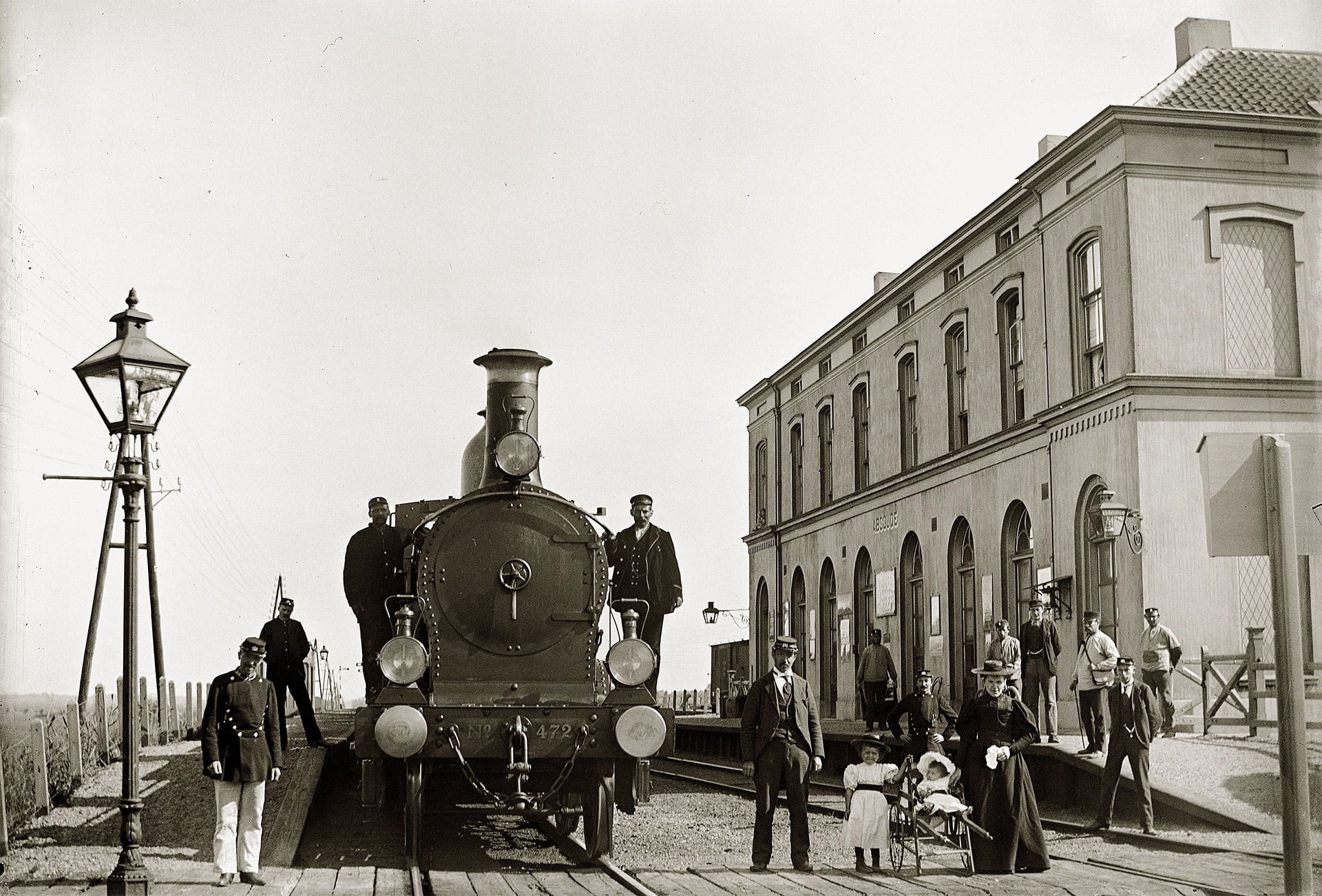 People standing around a locomotive in the city