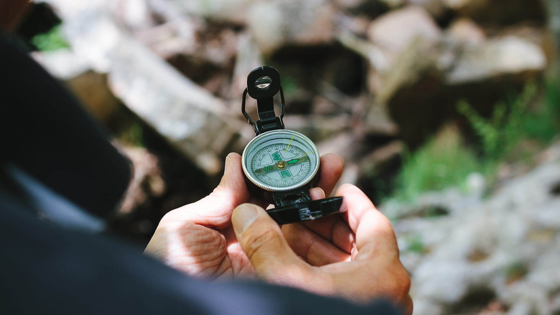 Person using a compass in the nature