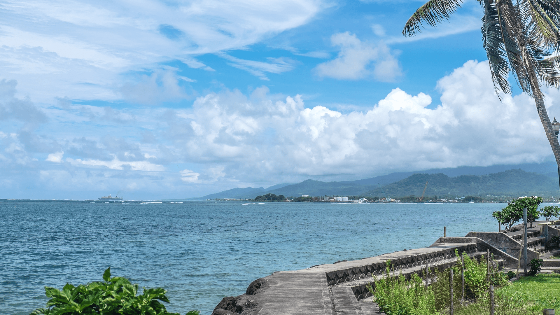 Apia harbour and waterfront, with commercial shipping port and container ship in background - Samoa, Upolu Island, South Pacific 