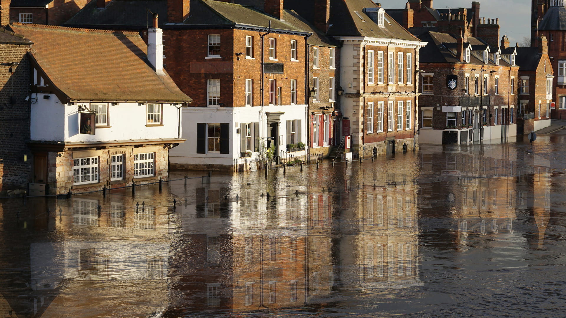 High river levels and flooded house by the river Ouse in York