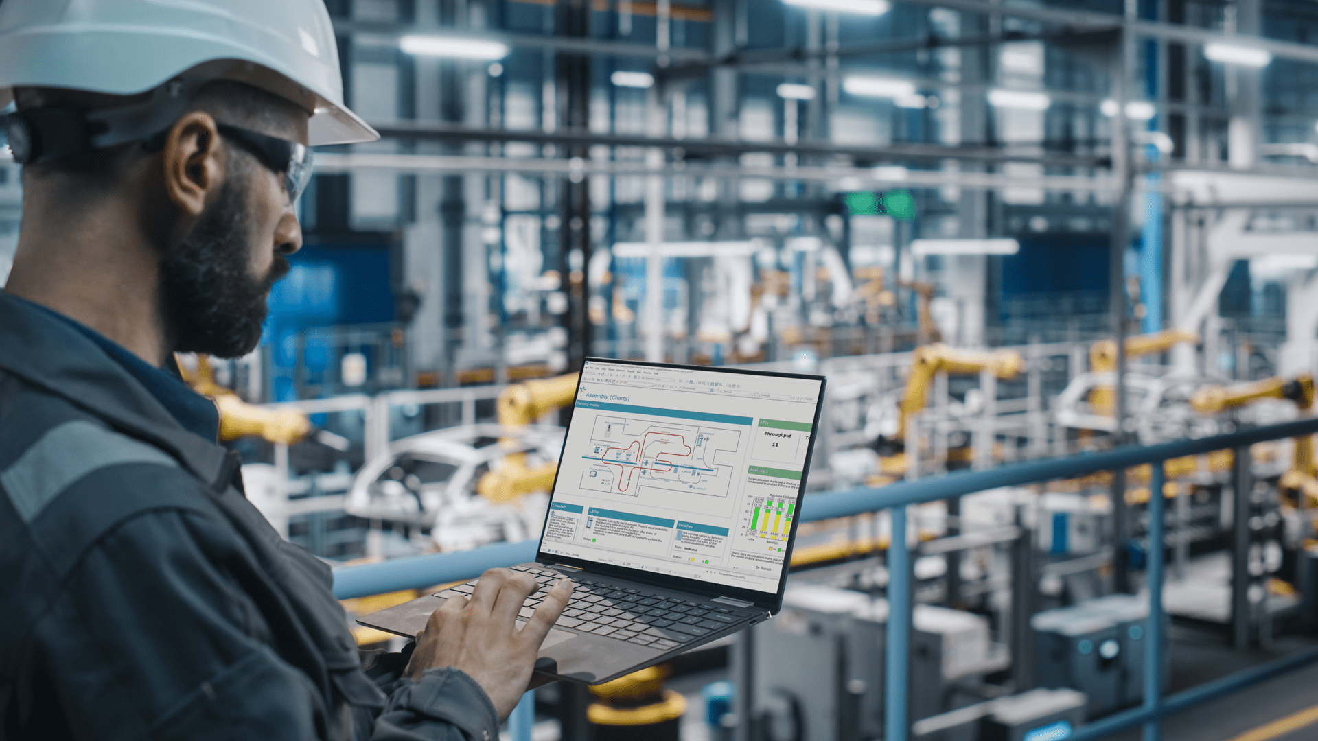 An operator uses Witness discrete event simulation software while looking down at the factory floor